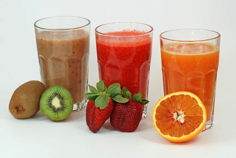 Diferentes tipos de jugos de frutas elaborados con una máquina exprimidora eléctrica.